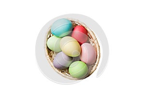 Basket of colorful Easter eggs isolated on white background. Easter basket filled with colored eggs top view holiday