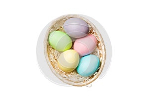 Basket of colorful Easter eggs isolated on white background. Easter basket filled with colored eggs top view holiday