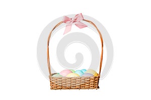 Basket of colorful Easter eggs isolated on white background. Easter basket filled with colored eggs top view holiday