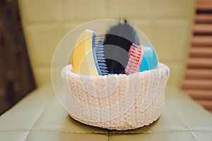 basket with combs and round hair brushes