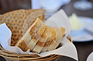 Basket with crisp bread and sliced wheat bread in closeup. Delicious and healthy breakfast. Crisp bread has lot of fibre