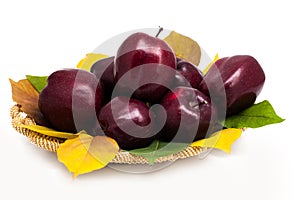 Basket of dark red apples on a white background