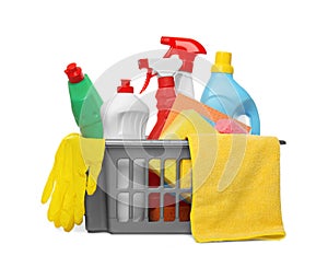 Basket with different cleaning products and tools on white background