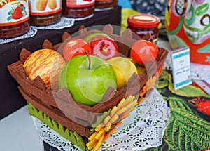 Basket with different fruits in the street shop of jam, compotes and jams photo