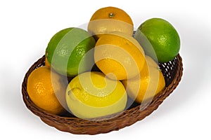 Basket with different tropical fruits isolated on white