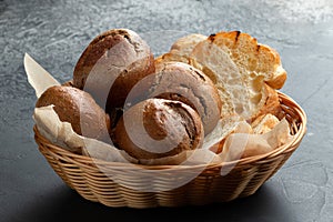 Basket with different types of bread. On a gray background