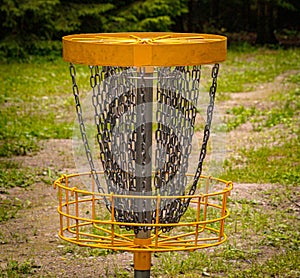 a basket for disc golf in the forest