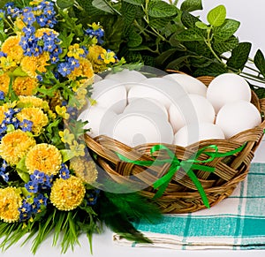 Basket with Easter eggs and spring flowers