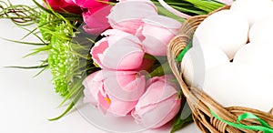 Basket with Easter eggs and spring tulips