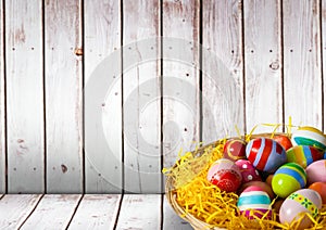 Basket with Easter eggs with wood background