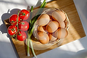 Basket of Eggs with a Bunch of Tomatoes