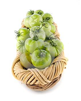 Basket filled with green tomatoes