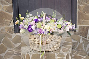 a basket of flowers on the steps in front of the front door