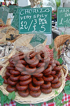 A basket of frankfurters or sausages at a farmers market