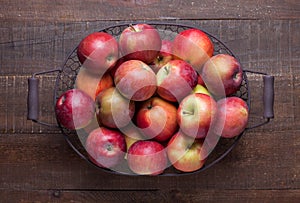 Basket with fresh apples on old rustic wooden table.  Top view.  Flat lay