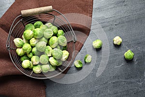 Basket with fresh Brussels sprouts on table, top view.