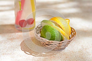 Basket with fresh citrus fruits on beige table, closeup