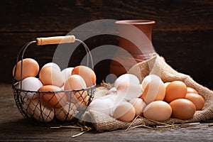 Basket of fresh eggs on a wooden table
