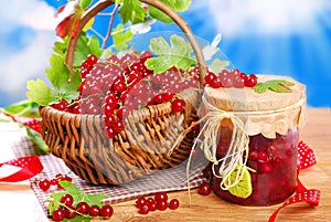 Basket of fresh red currant and jar of preserve