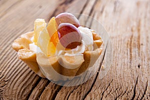 Basket fruit cake on wooden