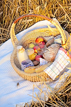 Basket full of apples, bread and milk