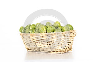 Basket full of brussel sprouts isolated on white