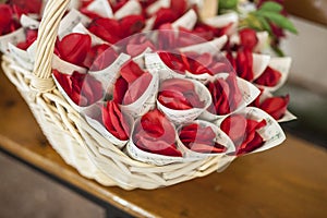 Basket full of cornets filled with red rose for wedding