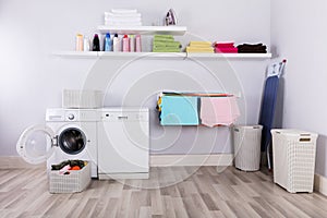 Basket Full Of Dirty Clothes In Laundry Room