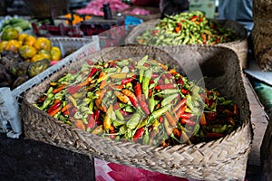 A basket full of fresh Indonesian chilli peppers, also called rawit or bird\'s eye chili