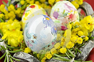 Basket full of handcolored Easter Eggs in decoupage closeup photo
