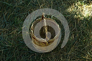 Empty Basket Green Meadow . Wicker Picnic Basket On The Fresh Summer Grass Overhead View. Weekend Resting Concept