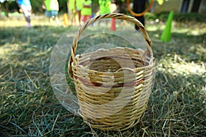 Empty Basket Green Meadow . Wicker Picnic Basket On The Fresh Summer Grass Overhead View. Weekend Resting Concept