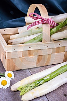 Basket with green and white asparagus with dark background