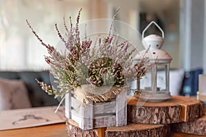 Basket with Heather on the table.heather in a basket . Autumn decorations.pink and purple flowers heather,heath in