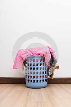 Basket with laundry on wooden floor