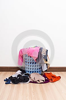 Basket with laundry on wooden floor