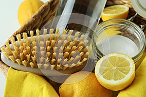 Basket with lemons, acid and brush, close up