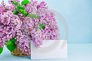 Basket of lilac pink flowers on blue background