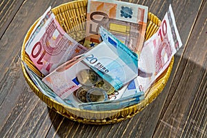 Basket with money from donations photo