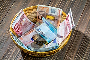 Basket with money from donations photo