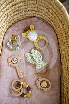 in a basket natural wooden knitted toys for a newborn. View from above