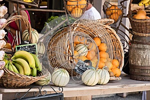Basket of oranges and melons in a market stand of Moustiers Sainte-Marie in Provence, France
