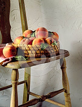 Basket of peaches on chair