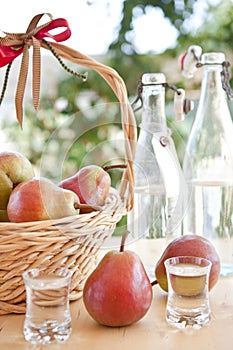 A basket with pears and pear schnapps