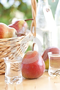 A basket with pears and pear schnapps