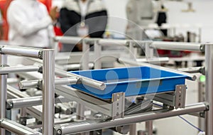 Basket or plastic box container on roller rack or aluminum shelf for easy transfer for industrial