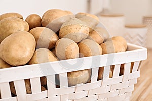 Basket with potatoes on kitchen counter. Orderly storage