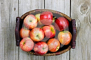 Basket of red apples on wood table