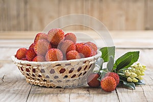 Basket with ripe arbutus unedo fruits