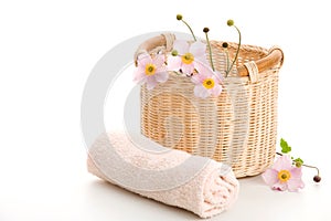 Basket, rolled towel and anemones